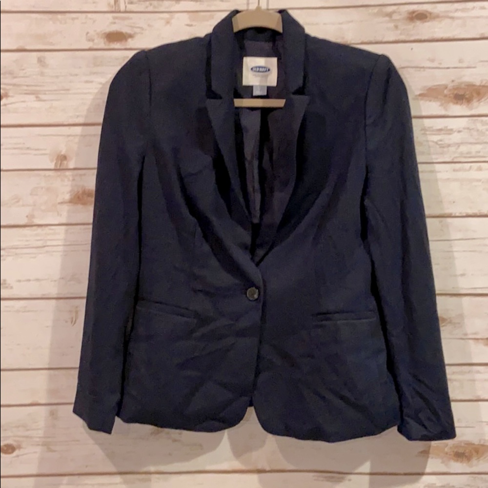 Navy blazer. One button. Shoulder pads